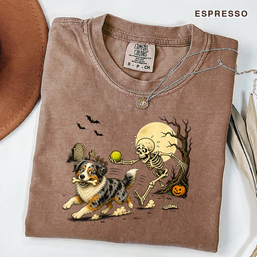 Skeleton Chasing Aussie Halloween Shirt T-Shirt in Espresso, vintage Halloween graphic tee with an Australian Shepherd and skeleton