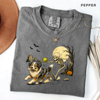 Skeleton Chasing Aussie Halloween Shirt T-Shirt in Pepper, vintage Halloween graphic tee with an Australian Shepherd and skeleton