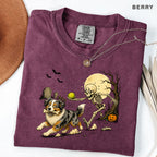 Skeleton Chasing Aussie Halloween Shirt T-Shirt in Berry, vintage Halloween graphic tee with an Australian Shepherd and skeleton
